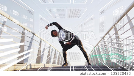 Stretching black athlete in sportswear bending on outdoor bridge with railings, with data overlays 135320483