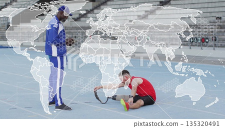 Stretching athlete using resistance band, coach checking stopwatch on track with empty bleachers 135320491