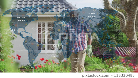 Watering gloved man tending poppies with watering can in front yard, with digital world map overlay Watering gloved man tending poppies with watering can in front yard, with digital world map overlay 135320493