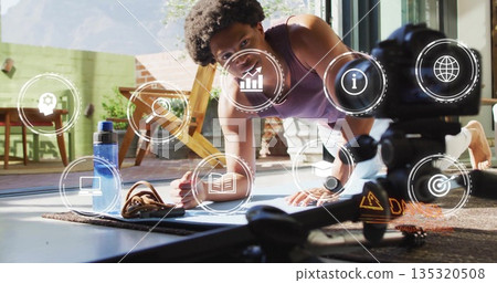 Fit man performing plank on patio mat, with camera tripod, water bottle and athletic shoes, icons Fit man performing plank on patio mat, with camera tripod, water bottle and athletic shoes, icons 135320508