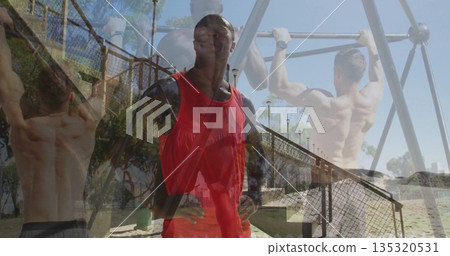Man in red top, black sleeves with crossbody strap supervising pull-ups on beach, with metal bars Man in red top, black sleeves with crossbody strap supervising pull-ups on beach, with metal bars 135320531