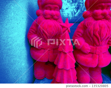 top view of a small ceramic doll on gray 135320805