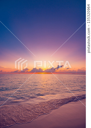 Vertical panoramic sunset beach close up ocean waves sand colorful sky summer background Vertical panoramic sunset beach close up ocean waves sand colorful sky summer background 135320964