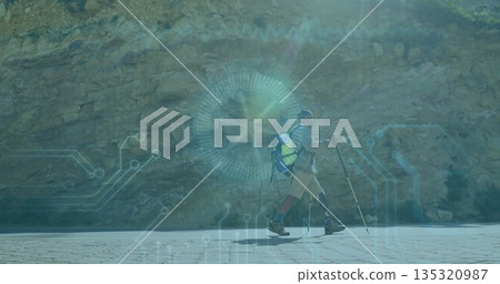 Hiking man with prosthetic leg navigating paved path at rocky cliff, tech overlay, copy space 135320987