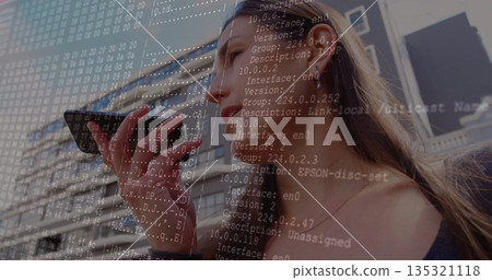 Adult man speaking into smartphone before office building facade, wired earphones, network overlay Adult man speaking into smartphone before office building facade, wired earphones, network overlay 135321118
