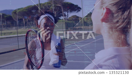 Standing tennis player holding tennis racket and water bottle on tennis court, with sports towel Standing tennis player holding tennis racket and water bottle on tennis court, with sports towel 135321130