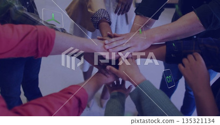 Uniting six colleagues stacking hands in office meeting space, with renewable energy icons overlays Uniting six colleagues stacking hands in office meeting space, with renewable energy icons overlays 135321134