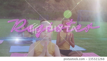 Sitting children pressing hands together on colorful yoga mats at park field, with soccer goalposts Sitting children pressing hands together on colorful yoga mats at park field, with soccer goalposts 135321268