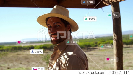 Smiling adult traveler turning head under wooden terrace, with straw hat, social icons, copy space Smiling adult traveler turning head under wooden terrace, with straw hat, social icons, copy space 135321315