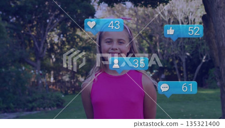 Smiling girl standing on well-kept grass lawn in backyard, with four floating social media bubbles 135321400