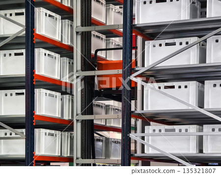 Storage system with clear containers in a warehouse during daylight 135321807