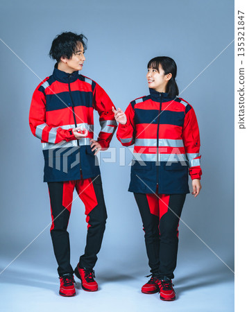 Full-body photo of a man and woman in uniform talking Full-body photo of a man and woman in uniform talking 135321847