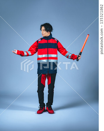 一名身穿制服的男子正在指揮交通。 一名身穿制服的男子正在指揮交通。 135321862