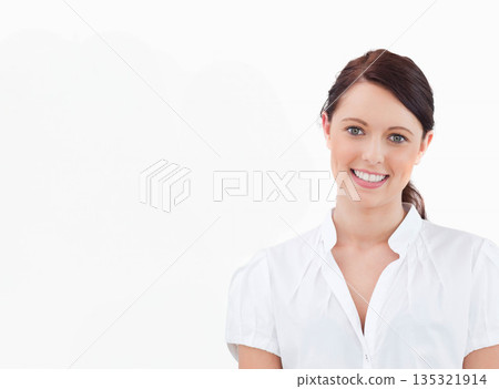 Female smiling while posing in studio against white backdrop with high-key lighting, copy space Female smiling while posing in studio against white backdrop with high-key lighting, copy space 135321914