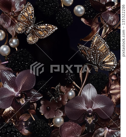 Decorative arrangement of butterflies and flowers in intricate design on a dark background during evening light Decorative arrangement of butterflies and flowers in intricate design on a dark background during evening light 135322286