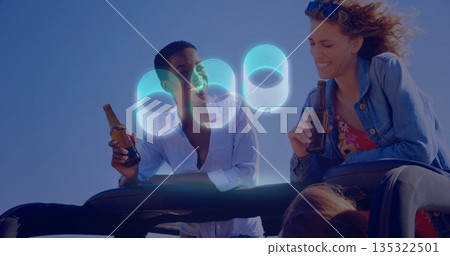 Two friends sitting on parked convertible under blue sky, with sunglasses and beer bottles Two friends sitting on parked convertible under blue sky, with sunglasses and beer bottles 135322501
