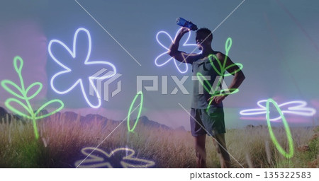 Male runner in sportswear drinking from water bottle in meadow by mountain ridge, copy space Male runner in sportswear drinking from water bottle in meadow by mountain ridge, copy space 135322583