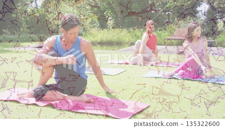 Woman in blue top, black leggings twisting in park by pond, with yoga mats, copy space 135322600