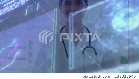 Monitoring female doctor examining floating holographic data on clinic glass wall, with stethoscope 135322649