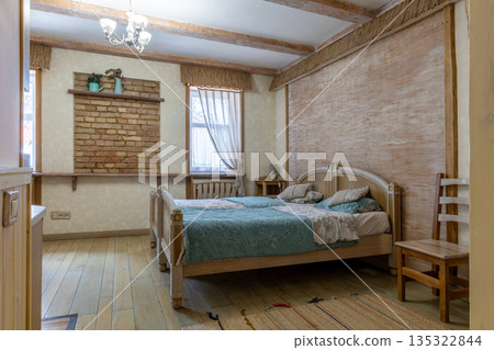 Rustic bedroom interior with woven wall texture and brick decor Rustic bedroom interior with woven wall texture and brick decor 135322844