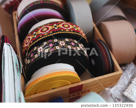 Antique flea market in Europe, Italy. Vintage items. Set of Europe thread ribbon on table, background for design. Antique flea market in Europe, Italy. Vintage items. Set of Europe thread ribbon on table, background for design. 135322930