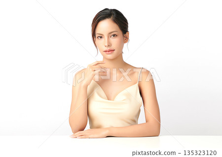 A beautiful young Asian woman with clean, fresh skin against a white background. Skincare, facial treatment, cosmetology, beauty, and spa. An elegant portrait of an Asian woman. 135323120