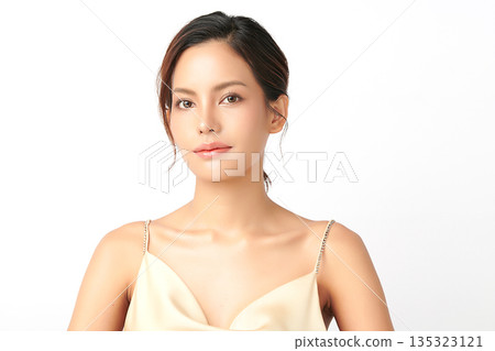 A beautiful young Asian woman with clean, fresh skin against a white background. Skincare, facial treatment, cosmetology, beauty, and spa. An elegant portrait of an Asian woman. 135323121