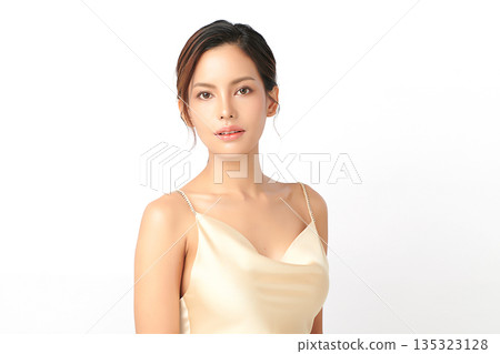 A beautiful young Asian woman with clean, fresh skin against a white background. Skincare, facial treatment, cosmetology, beauty, and spa. An elegant portrait of an Asian woman. 135323128
