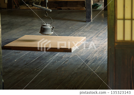 An irori hearth in an old house and an iron kettle hanging on a hook - a quiet Japanese-style room with a wooden floor An irori hearth in an old house and an iron kettle hanging on a hook - a quiet Japanese-style room with a wooden floor 135323143