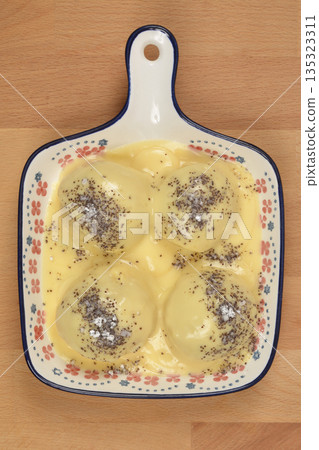 Sweet yeast dumplings in vanilla custard 135323311
