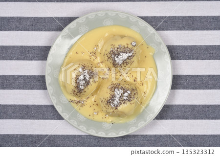 Sweet yeast dumplings on a striped background 135323312