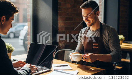 A Barista Smiling Warmly While Handing a Fresh Coffee to a Lone Worker in a Cozy Cafe Setting 135323962
