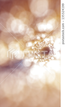 Soft golden bokeh circles forming a glowing abstract pattern with bright light at the center 135324199