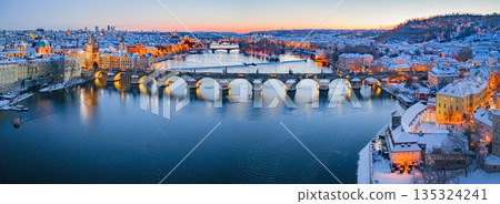 High Resolution Panorama Picture of Winter Snowy Prague Old Town with Prague Castle and Charles Bridge above River Vltava during Sunset , Czech republic 135324241