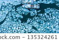 Small Boat Trapped in Ice due to Freezing of River in Winter , Aerial Shot 135324261