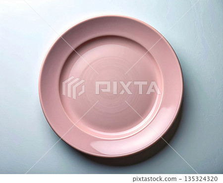 Timeless table setting. Ceramic plate with a classic pink design on a white background. Porcelain kitchenware. Close-up. Top view. Timeless table setting. Ceramic plate with a classic pink design on a white background. Porcelain kitchenware. Close-up. Top view. 135324320