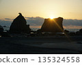 A rising sun on a bridge pile rock 135324558