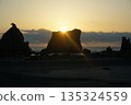 A rising sun on a bridge pile rock 135324559
