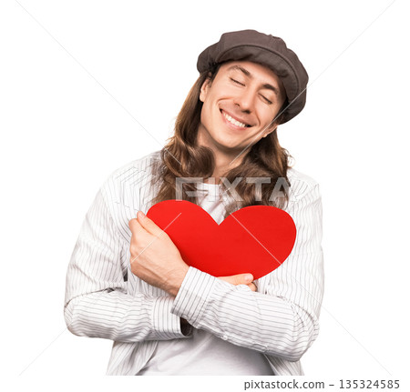 Happy man with long hair and cap hugging a red heart with eyes closed. Smiling romantic guy embracing love symbol isolated on white background. Valentine's Day concept. High quality photo Happy man with long hair and cap hugging a red heart with eyes closed. Smiling romantic guy embracing love symbol isolated on white background. Valentine's Day concept. High quality photo 135324585