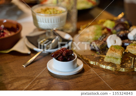 Muslim family sharing iftar in a restaurant with Ramadan decorations in a warm setting during the holy month 135324843