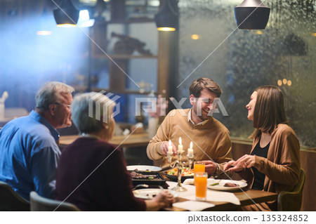 Muslim family enjoys iftar together in a restaurant decorated for Ramadan celebration Muslim family enjoys iftar together in a restaurant decorated for Ramadan celebration 135324852