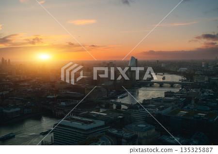 River Thames Flowing In The Middle Of London With Sun Rising  135325887