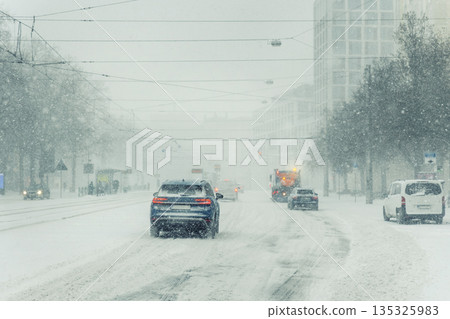 Heavy snowfall cover urban street Magdeburg car service truck move low visibility icy condition. Winter storm tram wire snow fill air traffic jam danger transport disruption harsh weather impact Heavy snowfall cover urban street Magdeburg car service truck move low visibility icy condition. Winter storm tram wire snow fill air traffic jam danger transport disruption harsh weather impact 135325983