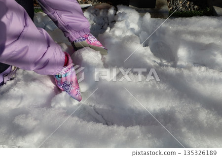 Children's hands enjoying playing in the snow, everyday winter scenery Children's hands enjoying playing in the snow, everyday winter scenery 135326189
