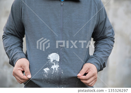 dirty flour stain on overcoat from cooking in kitchen. dirty stains for cleaning concept idea. dirty flour stain on overcoat from cooking in kitchen. dirty stains for cleaning concept idea. 135326297