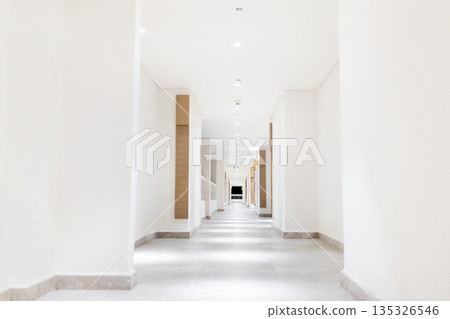 Empty modern hotel corridor with clean lines and room numbers, minimalist design Empty modern hotel corridor with clean lines and room numbers, minimalist design 135326546