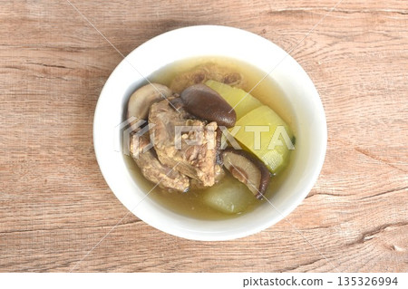 boiled winter melon with pork bone and black mushroom soup on bowl boiled winter melon with pork bone and black mushroom soup on bowl 135326994