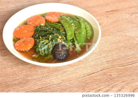 fried mixed vegetable dressing sesame oil and soy sauce with chop garlic on plate 135326996
