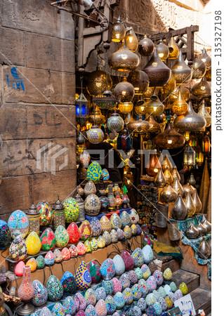 Khan el-Khalili market in Cairo features vibrant stalls filled with colorful goods. Diverse people browse the market, surrounded by traditional architecture and lively atmosphere. 135327198