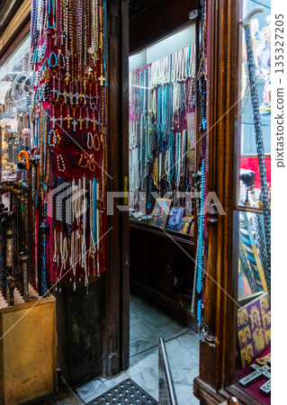 Khan el-Khalili market in Cairo features vibrant stalls filled with colorful goods. Diverse people browse the market, surrounded by traditional architecture and lively atmosphere. Khan el-Khalili market in Cairo features vibrant stalls filled with colorful goods. Diverse people browse the market, surrounded by traditional architecture and lively atmosphere. 135327205